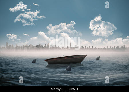 Sharks circling a small boat in the sea Stock Photo