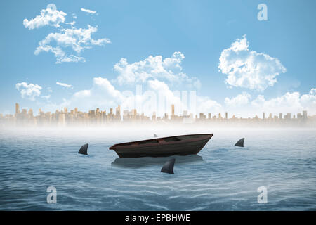 Sharks circling a small boat in the sea Stock Photo