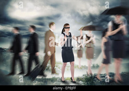 Composite image of redhead businesswoman in a blindfold Stock Photo