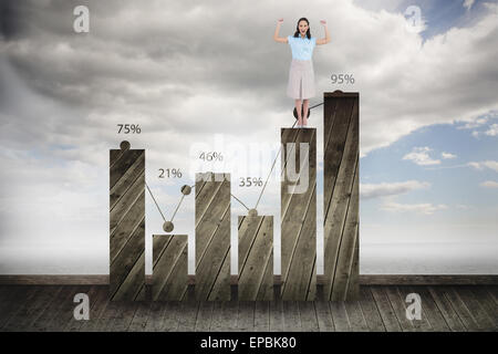 Composite image of victorious stylish businesswoman posing Stock Photo