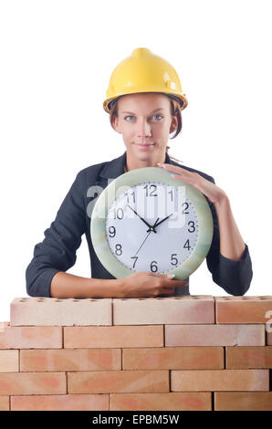 Female builder and clock on white Stock Photo - Alamy