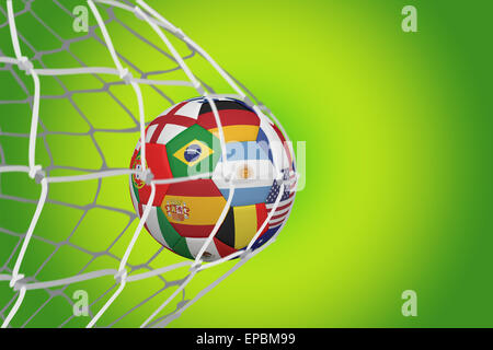 Football in multi national colours at back of net Stock Photo