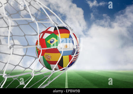 Football in multi national colours at back of net Stock Photo