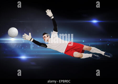 Goalkeeper in white making a save Stock Photo