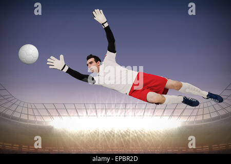 Goalkeeper in white making a save Stock Photo