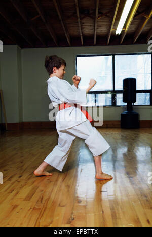 Boy in karate class demonstrating karate stance Stock Photo
