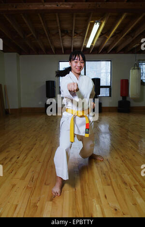 Girl in karate class demonstrating karate stance Stock Photo