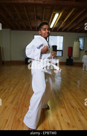 Boy in karate class demonstrating karate stance Stock Photo