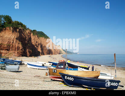 Small wooden fishing boats hauled up on Sidmouth Beach,Devon,England. Stock Photo