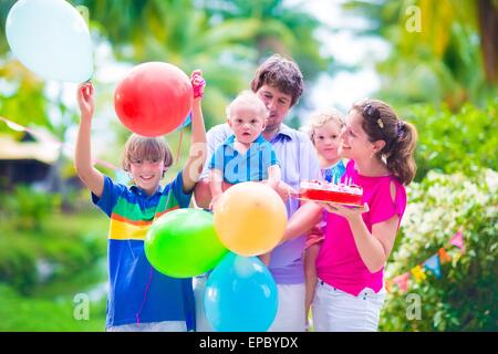 Happy big family, young parents with three children, teenager boy, little toddler girl and baby celebrating birthday party Stock Photo