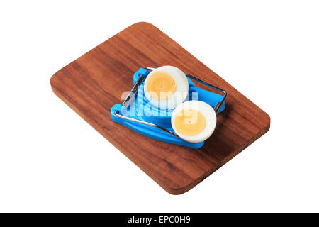 Halved boiled egg and an egg cutter Stock Photo