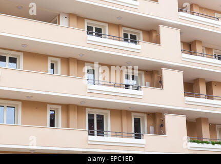 Pink facade of residential building with white windows. Stock Photo