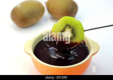 Chocolate fondue with kiwi Stock Photo