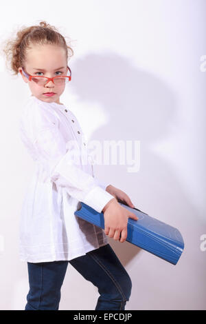 Basic school child with heavy file in the hand Stock Photo