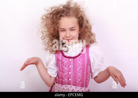 Small Bavarian girl in the dirndl in pose Stock Photo