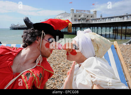 Brighton, UK. 16th May, 2015. A real life Punch and Judy take a break from performing at the Brighton Fringe Festival with a bit of sunbathing on the beach in glorious sunny weather today . Joanne Tremarco and Christopher Murray are from the Foolsize Theatre and are taking part in 'The Arcade of Fools' mini festival Credit:  Simon Dack/Alamy Live News Stock Photo