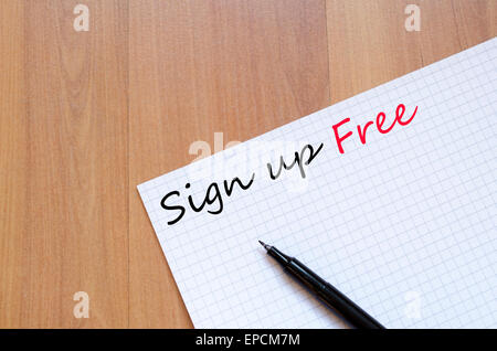 White blank notepad on office wooden table Sign up free concept Stock Photo