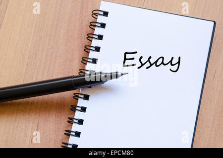 White notepad and ink pen on the wooden desk Essay Concept Notepad Stock Photo
