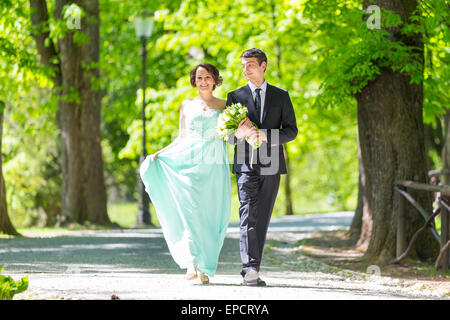 Wedding couple walking in park. Stock Photo