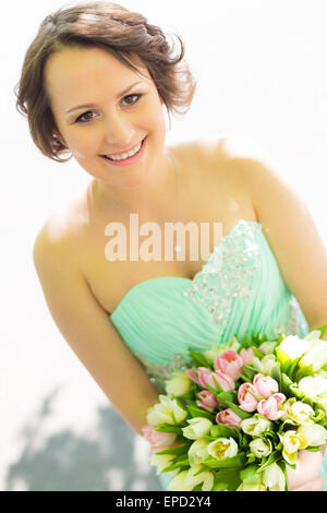 Happy bride with wedding bouquet. Stock Photo