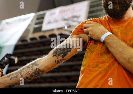 Athens, Greece. 16th May, 2015. A participant of a tattoo competition shows off his tattoo to the audience. Greek and international tattoo artists came to Athens for the 9th International Athens Tattoo Convention, showing off their talents in competitions and while tattooing visitors. © Michael Debets/Pacific Press/Alamy Live News Stock Photo