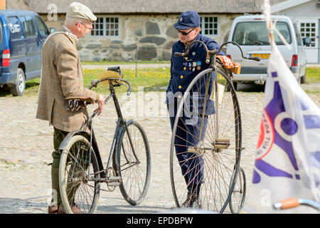 Solvesborg, Sweden. 16th May, 2015. International Veteran Cycle Association (IVCA) 35th rally. Costume ride through public streets in town. Two men talk. Credit:  Ingemar Magnusson/Alamy Live News Stock Photo