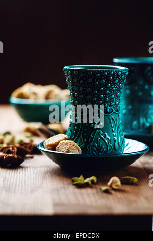 Authentic Drink with Various Spices in Traditional Turkish Glasses on Wooden Background, with Brown Sugar. Close up Shot. Select Stock Photo