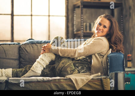 brunette woman in cozy cardigan putting paper cup into shopping bag  isolated on pink Stock Photo - Alamy