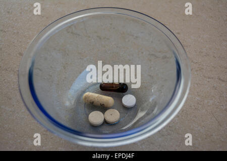Daily vitamins in a glass dish Stock Photo