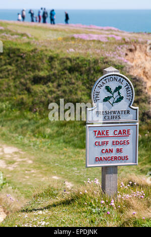 Take care cliff edges can be dangerous - The National Trust sign at Freshwater Cliffs at Isle of Wight, Hampshire UK in May Stock Photo