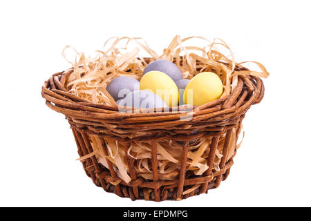 Easter egg in basket, isolated on white Stock Photo