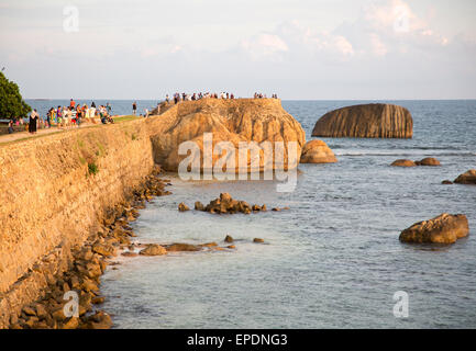 Tourists walk on fort ramparts in historic town of Galle, Sri Lanka, Asia Stock Photo