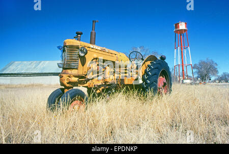 An ancient tractor sits abandoned in a field near Roy, New Mexico Stock Photo