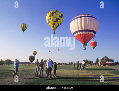 Hot air balloons take part in an early morning launch from a grassy field in silver City, New Mexico, over the 4th of July holiday Stock Photo