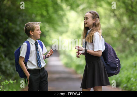 School pupils in uniform walking to school UK Stock Photo