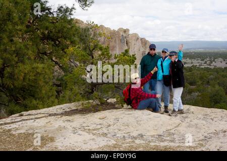 Family group on sandstone bluff at El Morro National Monument New Mexico - USA Stock Photo