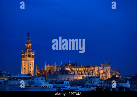 Saint Mary of the See largest cathedral in the world in Seville Spain at dusk with lights Stock Photo