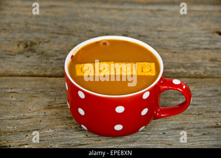 Tomato soup in a red soup mug with white polka dots on rustic wood ... Tomato soup in a red soup mug with white polka dots on rustic wood ...