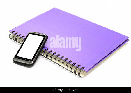 used smartphone with grey note book on a white background Stock Photo