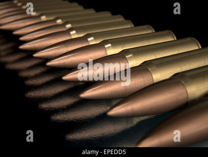 A macro close up view of a row of regular scratched brass and copper bullets on an isolated black background Stock Photo