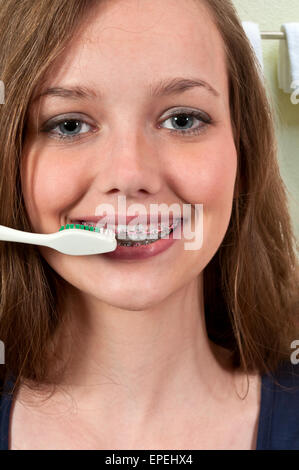 Beautiful Teenage Woman Brushing Teeth Stock Photo