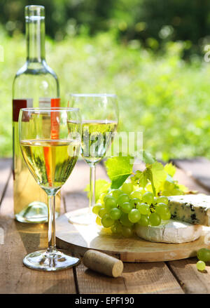 Cheese, grapes and two glasses of the white wine Stock Photo