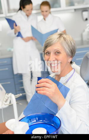 Elderly woman dentist team at dental surgery Stock Photo