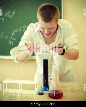 Crazy scientist at laboratory on chemical experiment Stock Photo