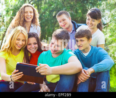 Students using tablet computer while doing homework Stock Photo