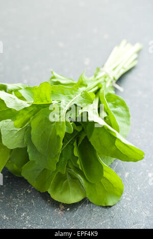 arugula leaves on kitchen table Stock Photo