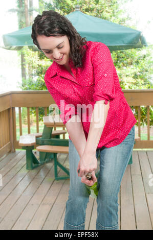 Woman Opening Wine Stock Photo