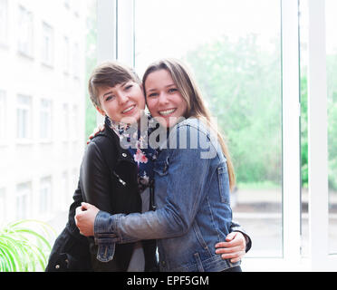 Two happy female students in classroom Stock Photo