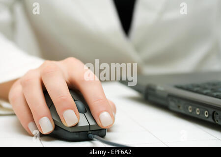 Female hand using computer mouse and keyboard Stock Photo