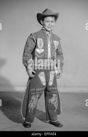 Boy dressed as cowboy Jeff Arnold for a Reveille feature on dressing up  2nd December 1957 Stock Photo